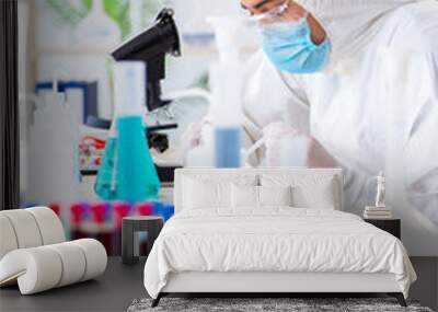 Young chemist student working in lab on chemicals Wall mural