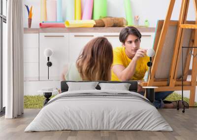 Young couple enjoying painting at home Wall mural