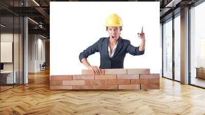 young female builder near brick wall Wall mural