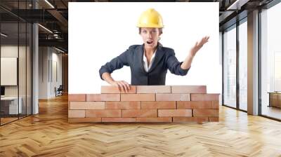 young female builder near brick wall Wall mural