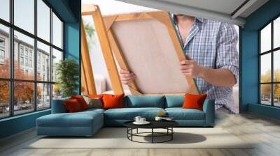 Young handsome man enjoying painting at home Wall mural