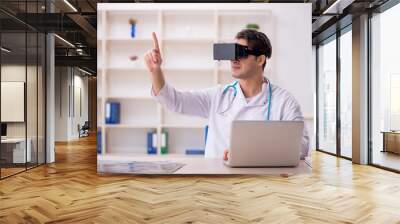 Young male doctor enjoying virtual glasses at the hospital Wall mural