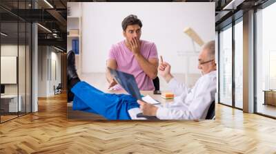 Young male patient visiting old male doctor radiologist Wall mural