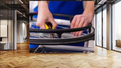 Young male repairer repairing wheel-chair indoors Wall mural