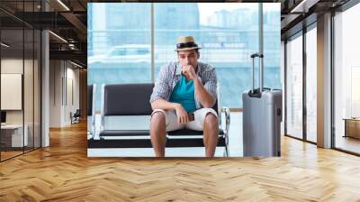 Young man travelling for his summer beach vacation Wall mural