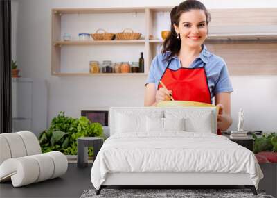 Young woman with vegetables in the kitchen  Wall mural