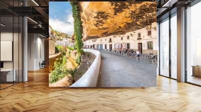 Restaurants in houses built in caves into rock overhangs above the Rio Trejo in the white village of Setenil de las Bodegas, Spain. Wall mural