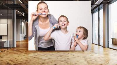 family mom and two blond boys brush their teeth Wall mural