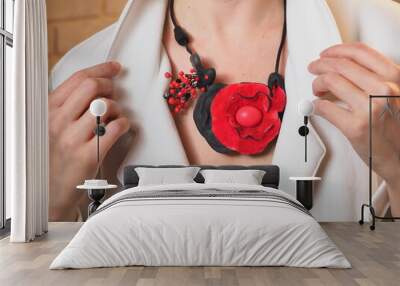 red necklace with a flower around the neck of a young woman Wall mural