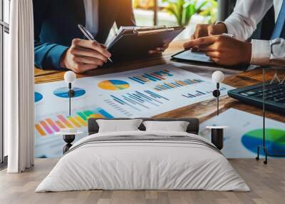 A businessman and finance analyst examine financial reports and economic growth graphs. They strategize, plan, and find solutions for budget management, business success, and financial investments.  Wall mural