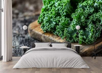 Vibrant green curly kale adorns a weathered wooden cutting board, creating a rustic and organic scene. The close-up perspective showcases the intricate texture of the leaves Wall mural