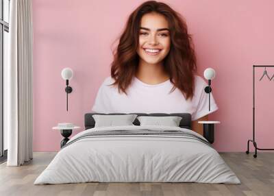 Smiling girl in white t-shirt on pink background mockup. Beautiful happy woman model looking at camera Wall mural