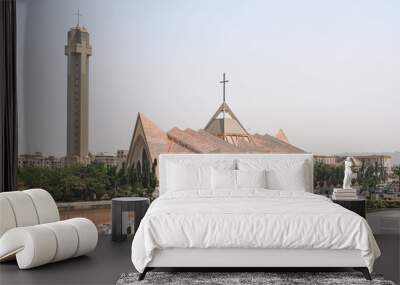 National Ecumenical center, a Christian building for religious ceremonies, in modern architecture style with spiked roof and cross shaped bell tower in Abuja, Federal Capital Territory, Nigeria Wall mural