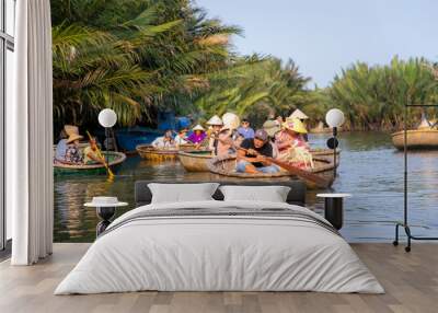 Touring the coconut palm forest on the river in bamboo basket boats Wall mural