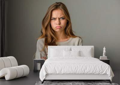 Sad, displeased, offended young woman expressing emotion Wall mural