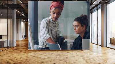 Can I take a look. Cropped shot of two attractive young businesswomen working together in the office. Wall mural