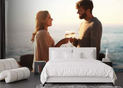 I want to do everything in this life with you. Shot of a happy young couple toasting with wine at the beach. Wall mural