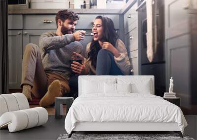 Ice cream, kitchen and couple on floor in home for bonding, relaxing and quality time together. Love, relationship and happy man and woman with sweet treats, dessert and luxury snack for romance Wall mural