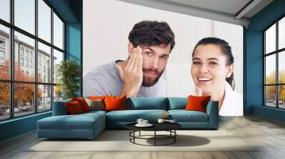 Keeping up appearances. Shot of a happy young couple going through their morning grooming routine together in the bathroom at home. Wall mural