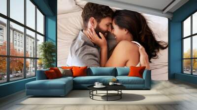 Smile, bed and happy couple hug, relax and spending lazy morning together, bonding and intimacy on Spain vacation. Happiness, marriage and top view of romantic man, woman or people embrace in bedroom Wall mural