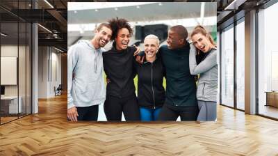 We make the best team. Cropped portrait of a diverse group of athletes standing together and smiling after an outdoor team training session. Wall mural