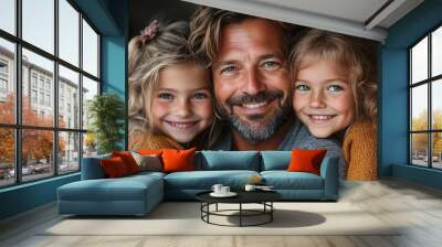 portrait of three little daughters hugging their happy father at home Wall mural