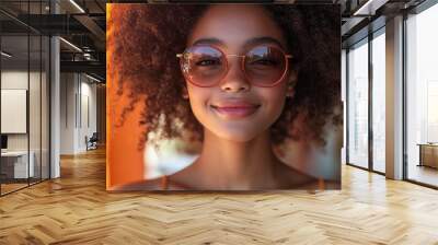 portrait of young happy multiracial teenage girl with sunglasses and afro hairstyle standing outdoor Wall mural