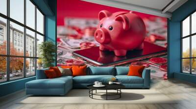 A red piggy bank sits on a smartphone surrounded by dollar bills and coins. Wall mural