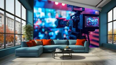 A video camera is positioned in front of a television screen, capturing the scene playing on the screen. Wall mural