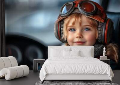 Happy child in driver seat wearing goggles dreams of becoming a pilot during a sunny day Wall mural