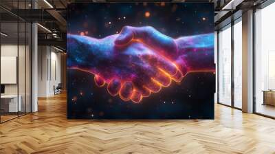 The hands of two individuals come together in a handshake, illuminated with vibrant colors, representing connection and partnership. Wall mural