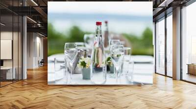 glass of water and bottle on table Wall mural