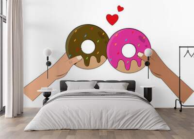 Manos sosteniendo donas de chocolate y fresa, chocando entre si con corazones. Con fondo transparente  Wall mural