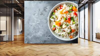 Colorful vegetables mixed with cooked white rice in a white bowl, photographed from above with empty space on the right. Wall mural