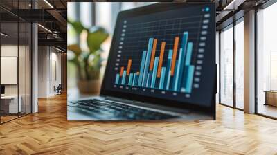 A bar chart on a laptop screen showing upward business trends Wall mural