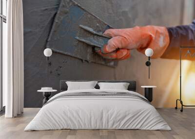 Close-up shot of a cement worker using a trowel to plaster the walls Wall mural