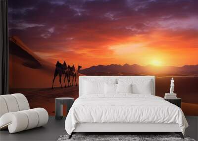 Desert landscape sunset and side way camels walking on the desert Wall mural