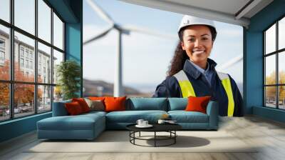 Female engineer standing at a wind turbine farm Wall mural