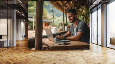 Young lifestyle digital nomad working on the laptop at Laos Wall mural