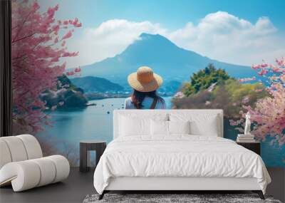 Asian woman traveler with backpack enjoys breathtaking views of mountains, sea, sakura blossom,and lakeside landscape in spring season.Relax and Wellness Holidays Concept. Wall mural