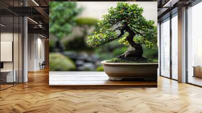 Miniature bonsai tree in a decorative pot placed in a garden setting with a blurred green nature garden background,copy space for text. Wall mural