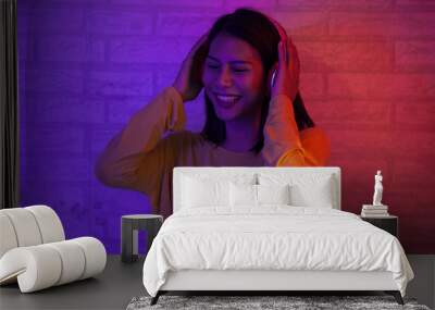 Fashion girl with red and blue light happy and relax with music from head phone  Wall mural