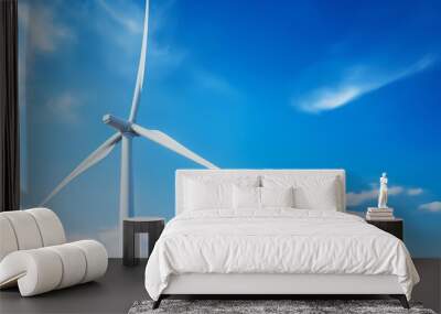 Wind turbine against blue sky with white clouds. Clean energy concept. Wall mural