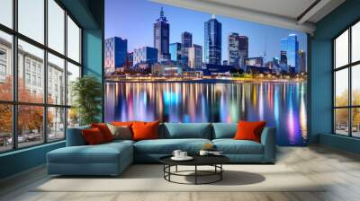 A stunning city skyline at night, featuring towering skyscrapers with lights twinkling like stars. Wall mural