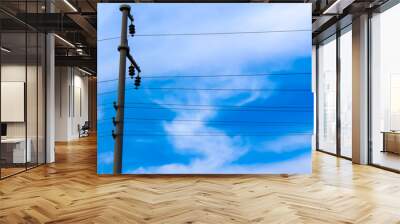 Cloudy blue sky and electric pole. Wall mural