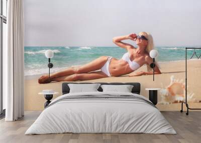 beautiful slender young blonde woman in white bikini lying Wall mural