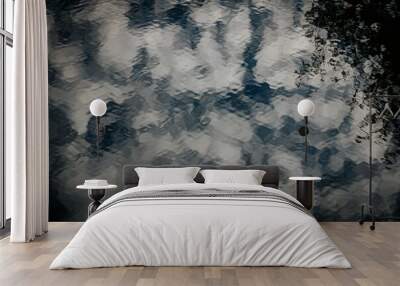 A soft, abstract cloudscape with fluffy white clouds scattered across a moody, dark blue sky. The clouds create a dreamy, atmospheric effect. Wall mural