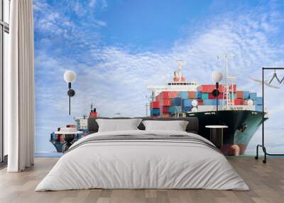 container cargo ship in the ocean with birds flying in blue sky, freight transportation. Wall mural