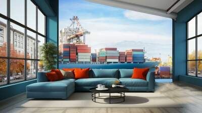 Logistics and transportation of International Container Cargo ship with working crane bridge in seaport for logistic import export background and transport industry. Wall mural