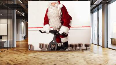 santa claus training on exercise bikes at the gym Wall mural